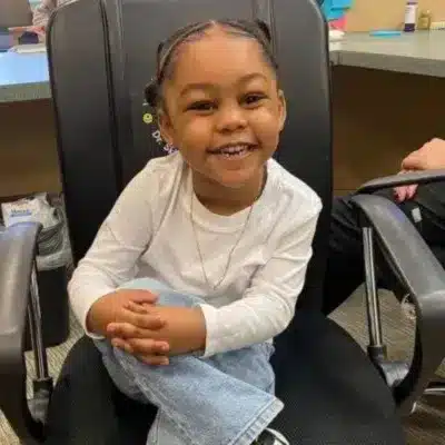 Our comprehensive pediatric dental services 4 Little girl smiling in a dental chair, representing comprehensive pediatric dental services