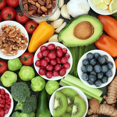An array of healthy vegetables and fruits on a tabletop, representing healthy foods for kids teeth