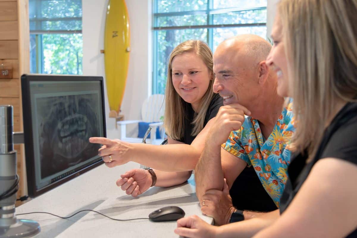 Dentist reviewing bitewing and panoramic dental X rays at Wilmington Pediatric Dentistry