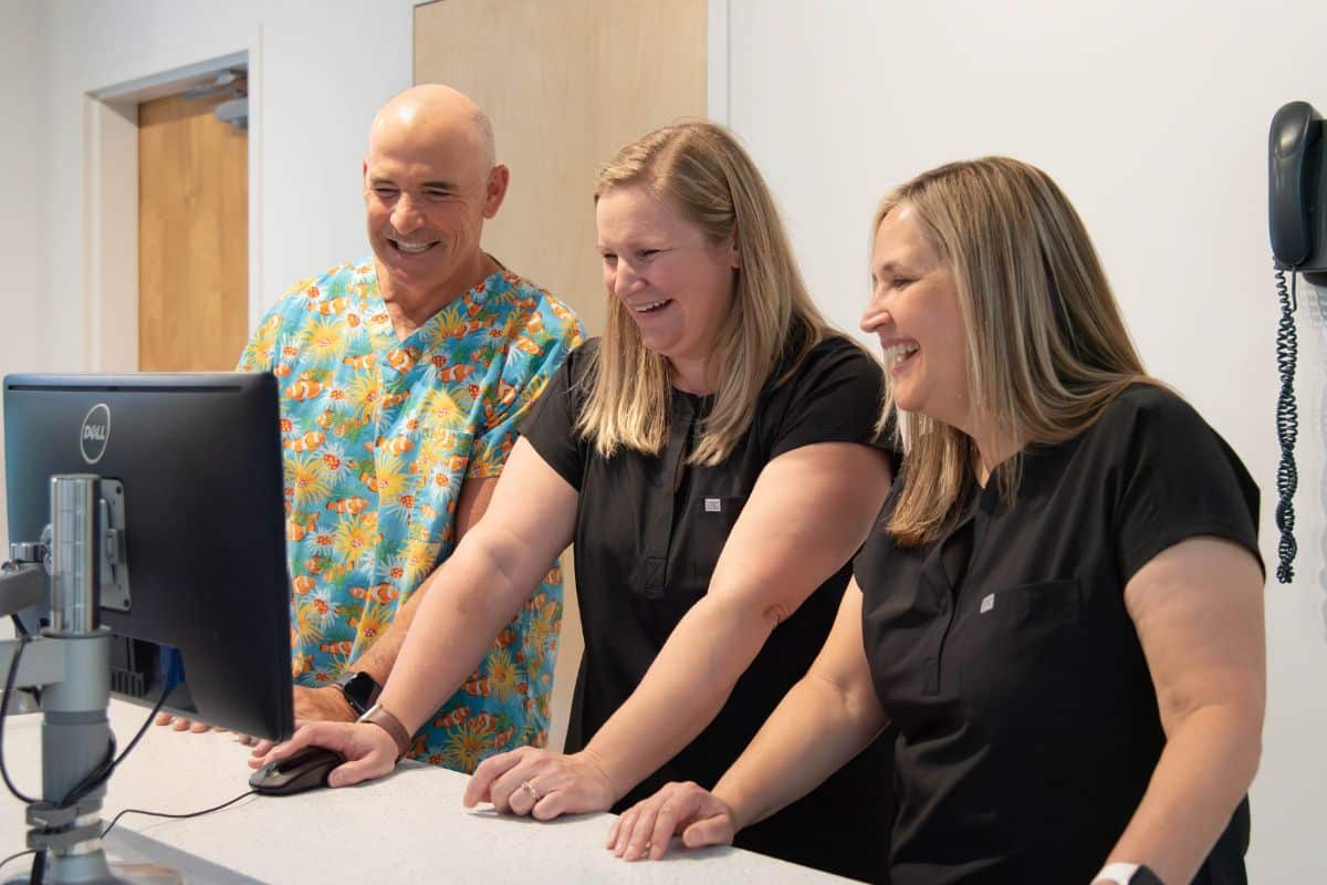 Dental staff reviewing an X-ray with the dentist at Wilmington Pediatric Dentistry.