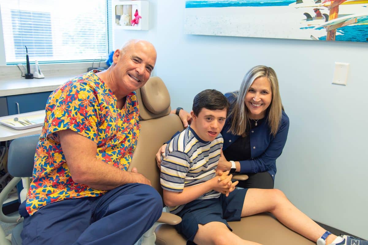 Dentist and dental hygienist smiling together at Wilmington Pediatric Dentistry providing care for children with special healthcare needs