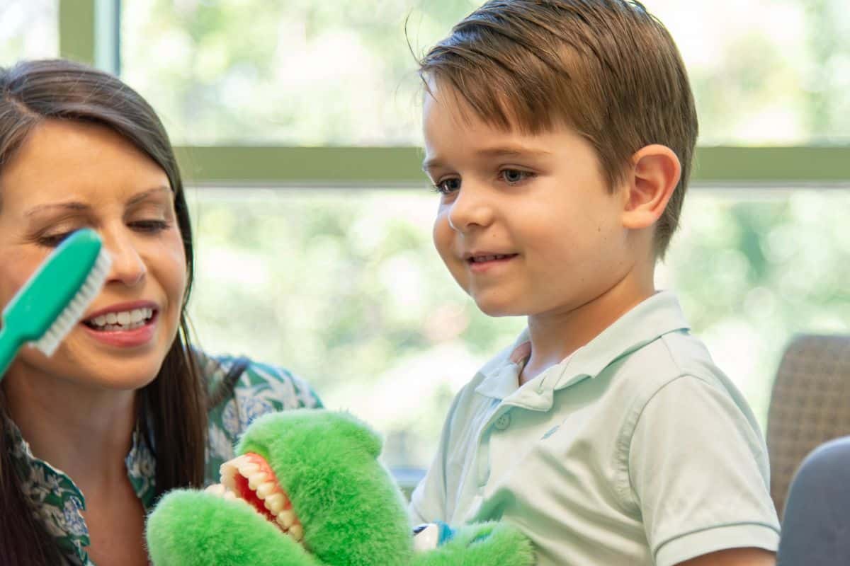 Little boy smiling at Wilmington Pediatric Dentistry for patient survey page.