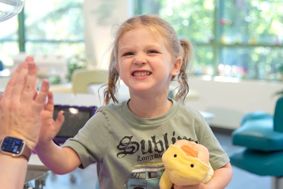 Little girl smiling after dental cleaning and fluoride treatment at Wilmington Pediatric Dentistry