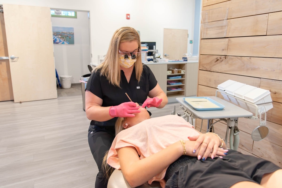 Pediatric dentist providing a gentle dental exam for a child at Wilmington Pediatric Dentistry.